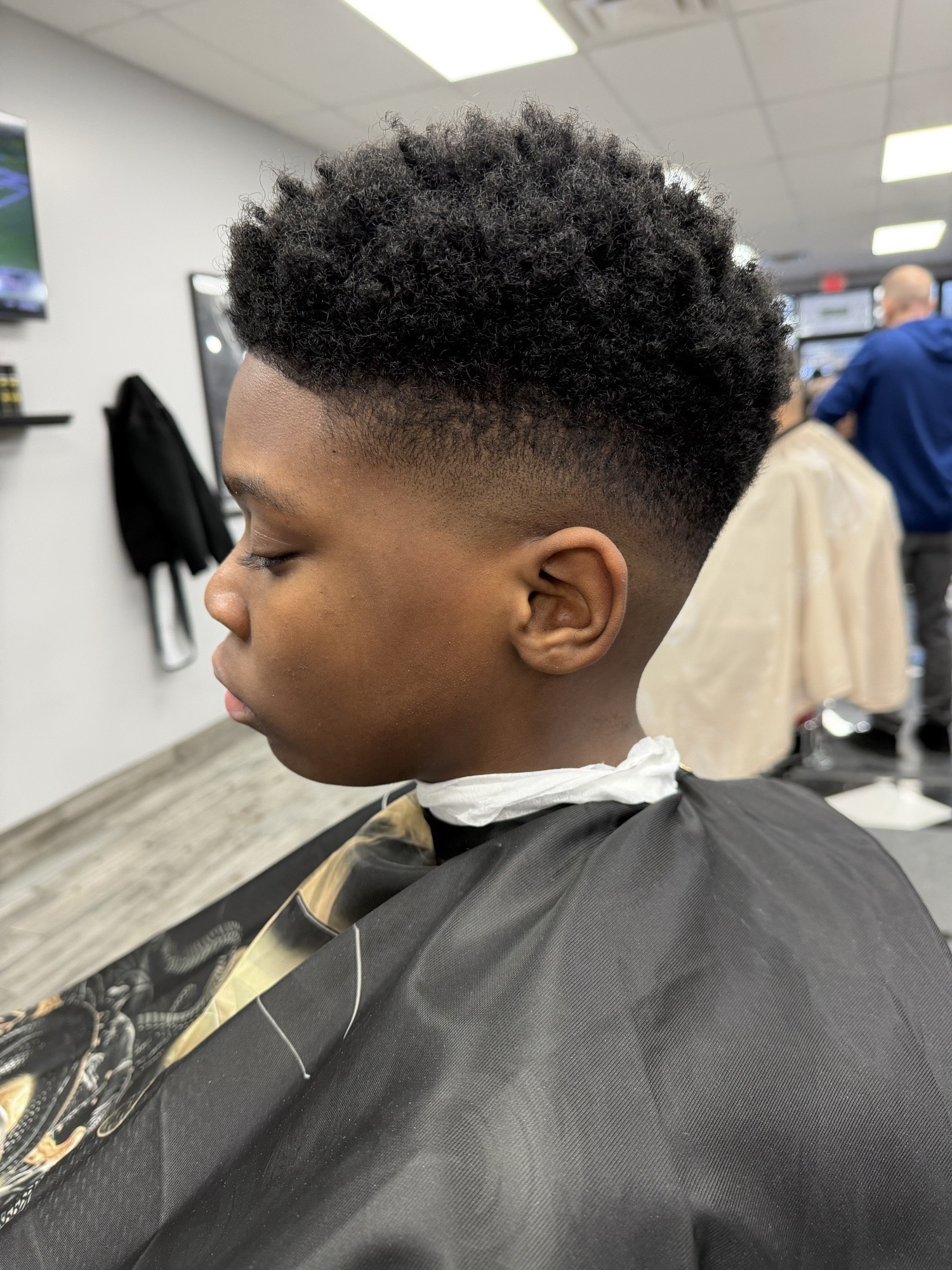 Textured taper fade with curly top — X Express Barbershop